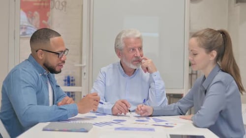 Diverse Team Collaborates on Business Data in Office