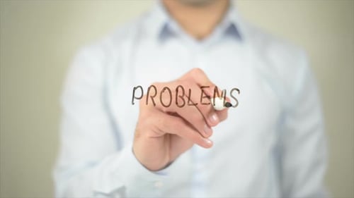 Man Writes Problems on Clear Surface