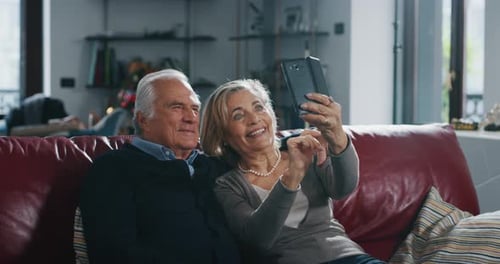 Senior Couple Taking a Smartphone Selfie Indoors