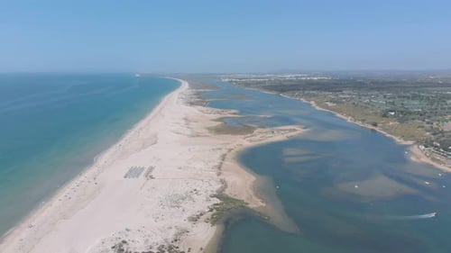Aerial view of beautiful bay. Ocean and river side by side separated by sand bank.