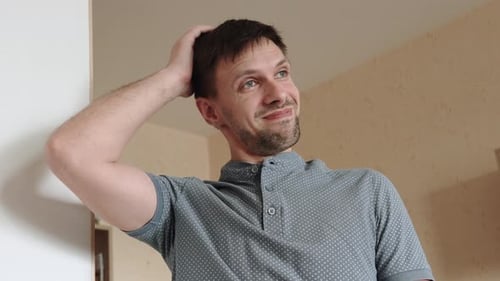 Pensive Man Scratching Head Indoors