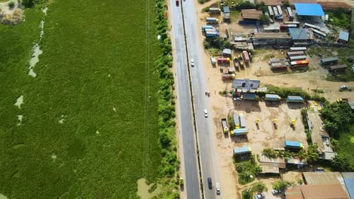 Vehicles are moving from a beautiful road in Dhaka city nearby a lake