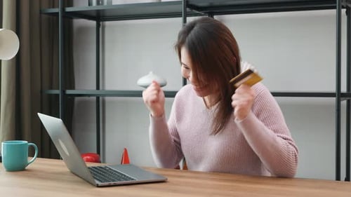 Woman at Desk Celebrates Online Shopping Success