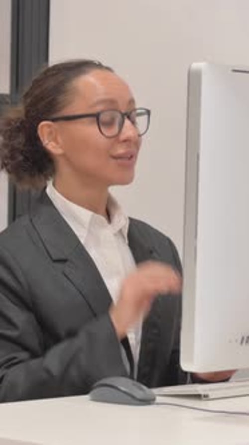 Woman in Blazer Talks on Computer Conference Call