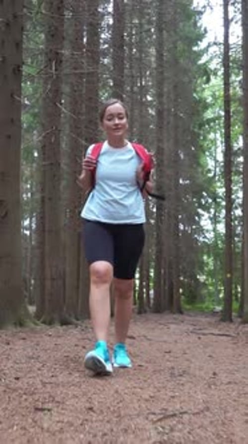 Woman with Backpack Walking in National Park