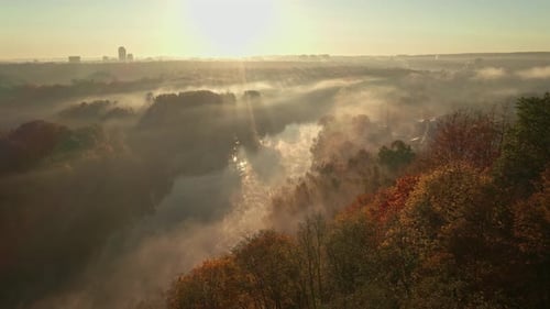 Morning Sunlight Pierces Mist Over the Calm Neris River Framed By Fall Foliage and Forests