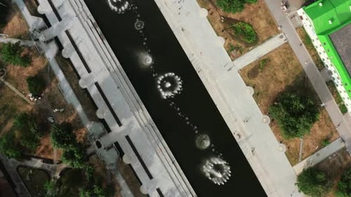 View of small fountains taken from a helicopter. Summer time with fountains and small houses