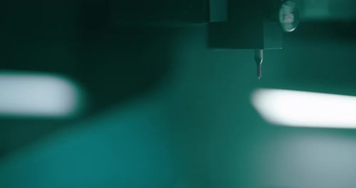 Precision Machinery Needle Mechanism in Dark Factory Setting