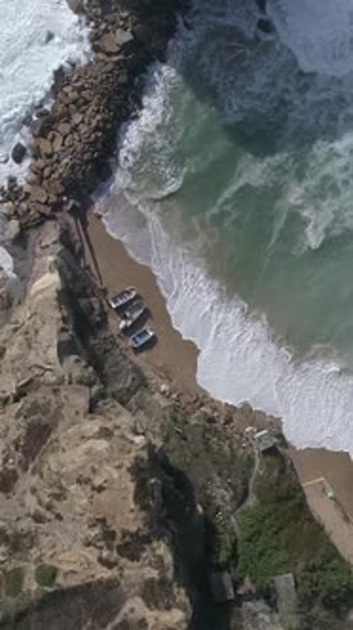 Vertical Video of Sea Waves Crashing Against Beach Cliffs