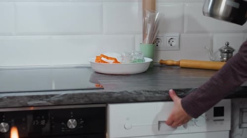 Partial View Person Taking Pot From Electric Stove Returning Into Kitchen Cabinet