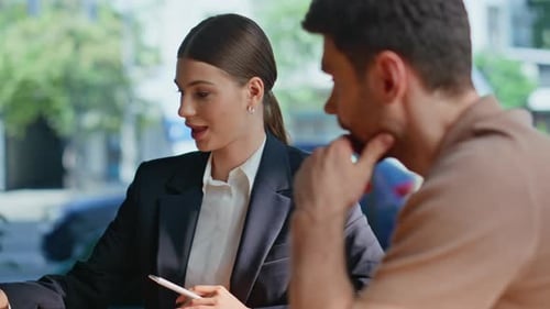 Businesswoman Discussing Contract with Client, Signs Agreement