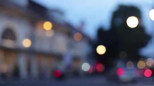 Blurry footage of street and car light passing on the road in the dark afternoon