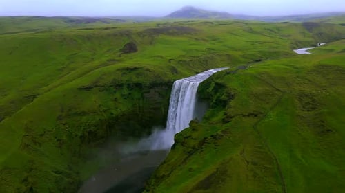 Majestic Waterfall Cascading Through Green Landscape