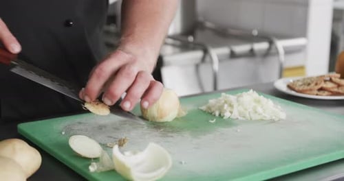 Chef Dicing Onion in Commercial Kitchen with Precision