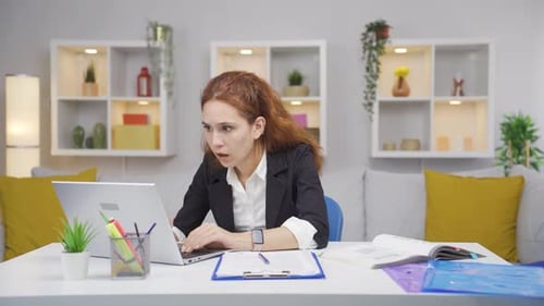 Home office worker woman shocked by what he reads and sees.