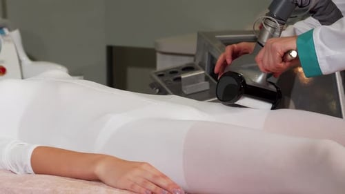 Radiant Young Woman Enjoying an LPG Massage Session at a Modern Cosmetology Clinic