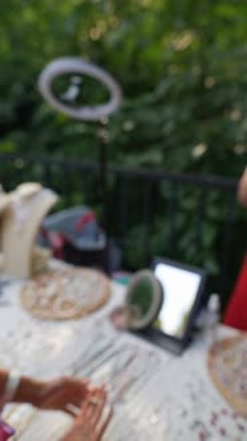 Woman Arranges Jewelry at Outdoor Urban Market