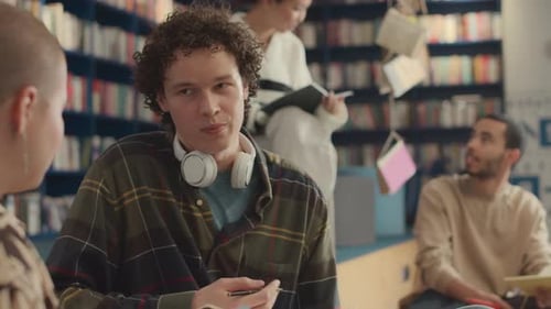 Multiracial Young Students Hanging out in Library