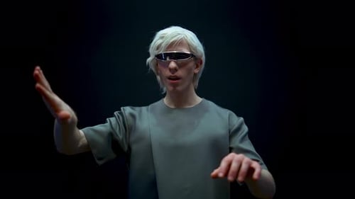Man Wears Futuristic Glasses Interacting with Technology