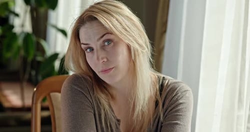 Woman with Fair Hair Looking at Camera Indoors