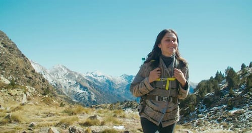 Contented Female Traveller Walk on Beautiful Mountain Landscape with Backpack