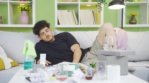 Young Adult Recovers on Couch After Messy Party