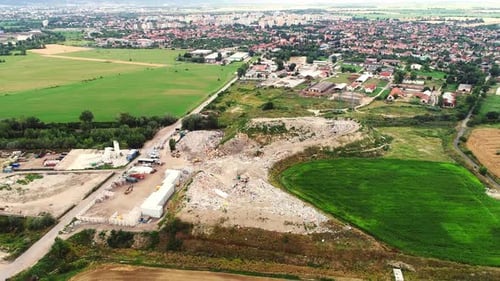 Aerial drone view of open landfill site with piles of waste. Garbage dump near a city. Environmental