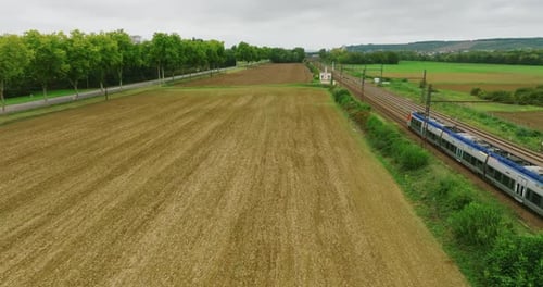 Aerial View of Fast Passenger Train Driving on Railroad