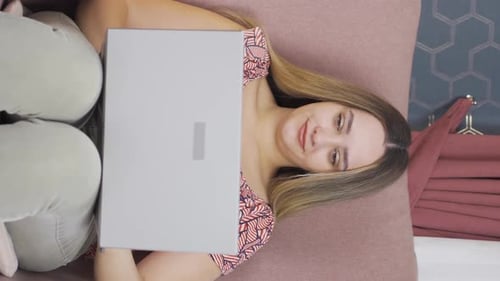 Young Woman Lies Down With Package