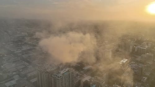 Sunset Cityscape with Smoke in the Distance