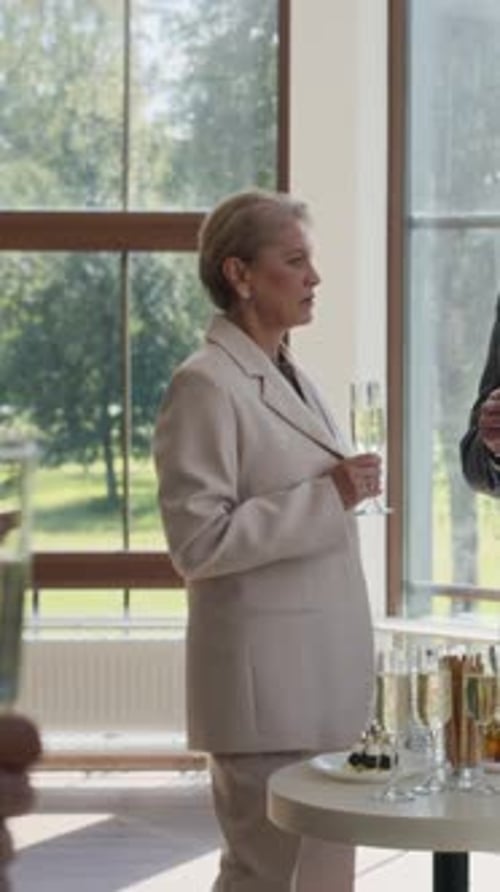 Vertical of Diverse Business People Clinking Glasses at Small Afterparty