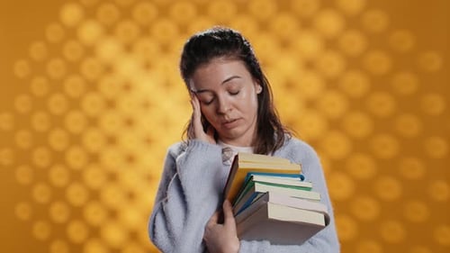 Woman Feeling Migraine Pain From Textbooks Needed for Homework
