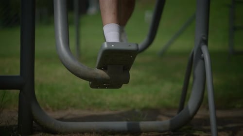 Legs Exercising on Outdoor Workout Machine in Park