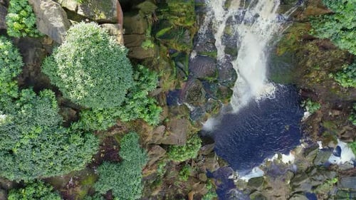 Aerial drone footage of a tall rocky waterfall in the Yorkshire Dales, Pennies. Moorland scene of a