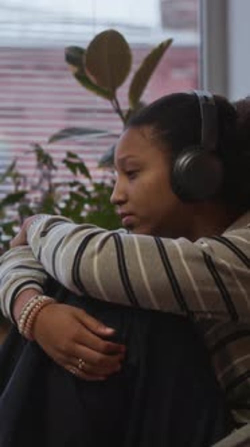 Frustrated Girl Listening to Music in Headphones