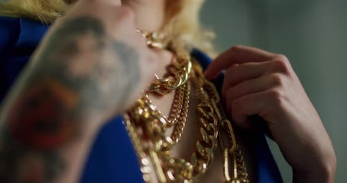 Woman Posing with Gold Chain Necklaces and Tattoo