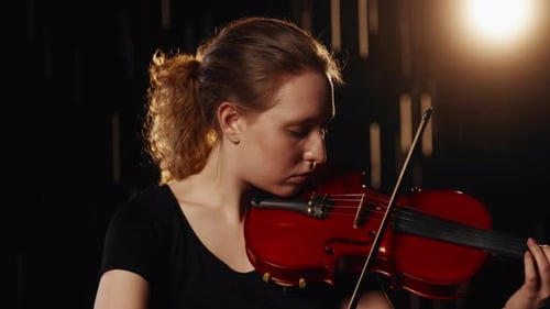 Rain on Stage of Theatre Beautiful Woman Musician Playing Violin in Darkness Inspiration and Talent