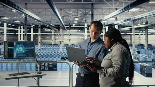 Technicians Working Together in Server Room Optimizing Deep Learning AI Systems