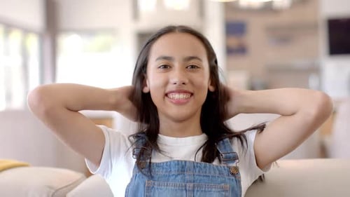Smiling Teen Runs Hands Through Hair Indoors