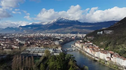 Panoramic Aerial View of Grenoble City Center Featuring Bridges Over Isere River and Snowy Mountains