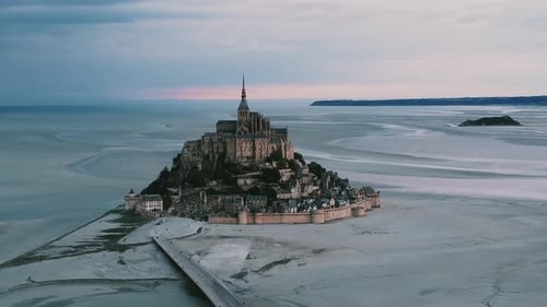Mont-Saint-Michel Abbey And Island On A Beautiful Sunset In Normandy, France. wide aerial