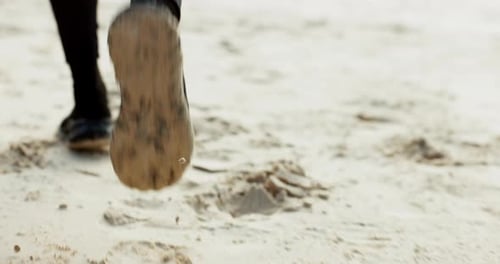 Running, fitness and feet of person on beach for exercise, marathon training