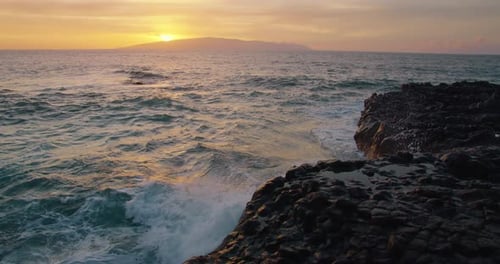 Slow Motion of Ocean Waves Hit on Rock Beach with Sun Set Over the Island La Gomera