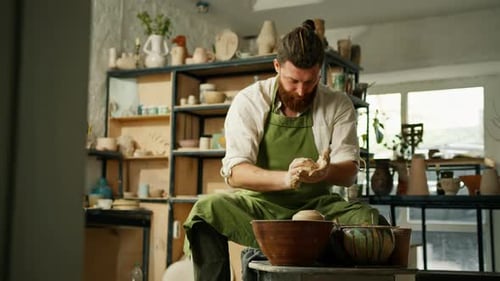 A man makes a clay pot on a ceramic wheel Ceramics Close-up A potter does pottery handicraft