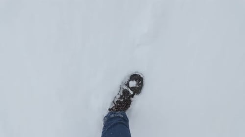 Leg Walking Through Untouched Snow POV