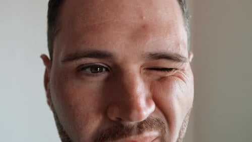 Man Closing One Eye At The Time