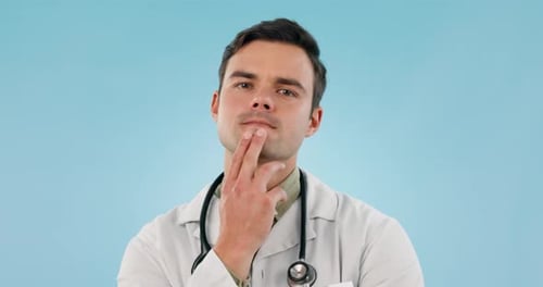 Thinking, man and doctor face in studio for idea, brainstorming or problem solving medical work