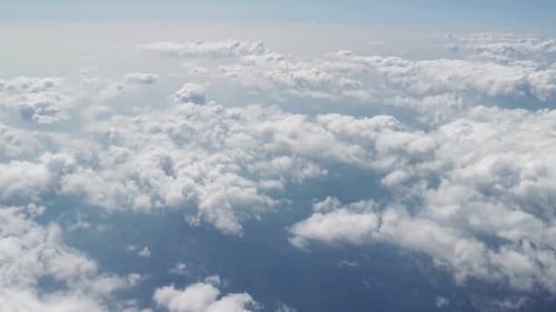 White Clouds and Blue Sky View From the Plane Flight at High Altitude Troposphere