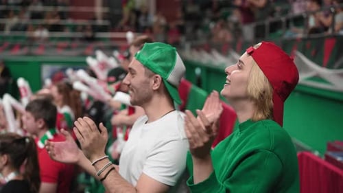 Happy fan people cheering at basketball stands. Sport stadium crowd bet clapping