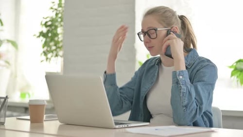 Woman Talking on Smartphone in Office Workplace